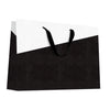 Sac luxe papier gaufré effet lézard noir et blanc avec poignées ruban noir, format horizontal