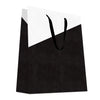 Sac luxe papier gaufré effet lézard noir et blanc avec poignées ruban noir, format vertical